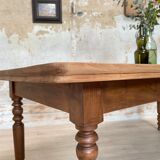 Vintage farmhouse table with turned legs.