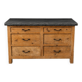 Old wooden workshop furniture with a stone top.