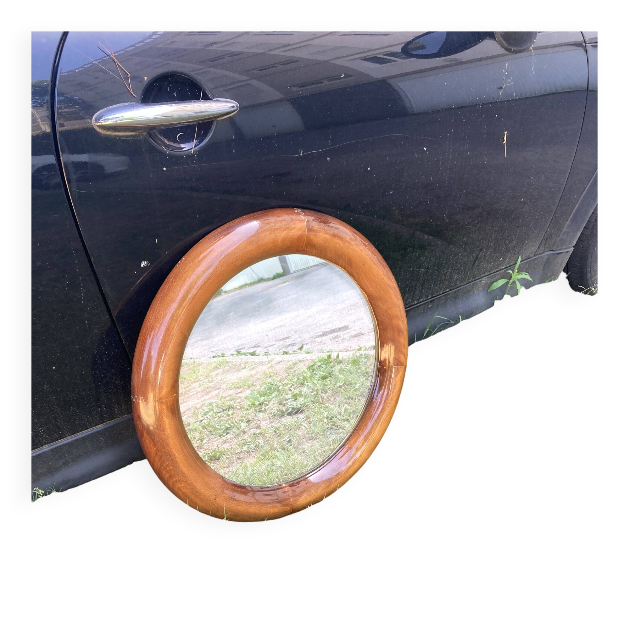 Round varnished wooden mirror