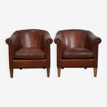 Set of two vintage sheep leather club armchairs with a rugged character