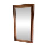 Large bevelled tabletop mirror in carved gilded wood.