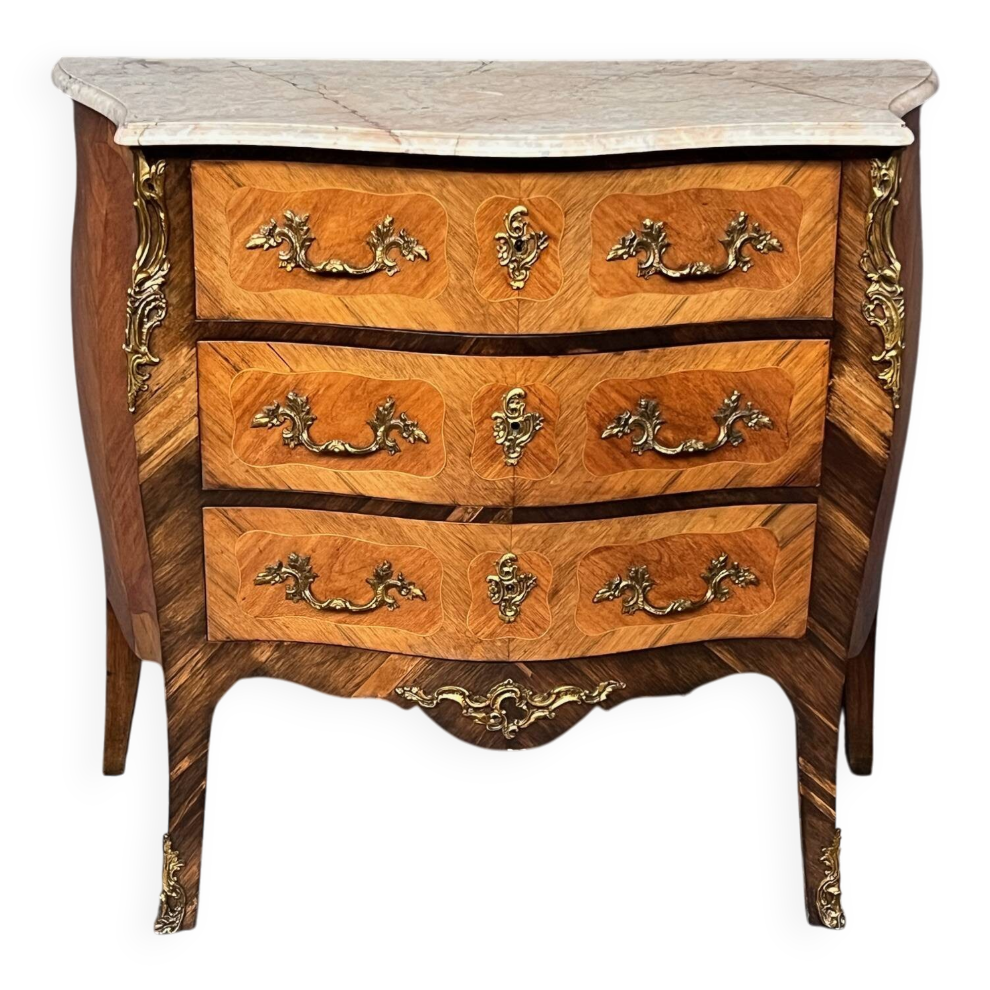 Louis XV style commode with rosewood veneer, gilded bronze mounts, and marble top.