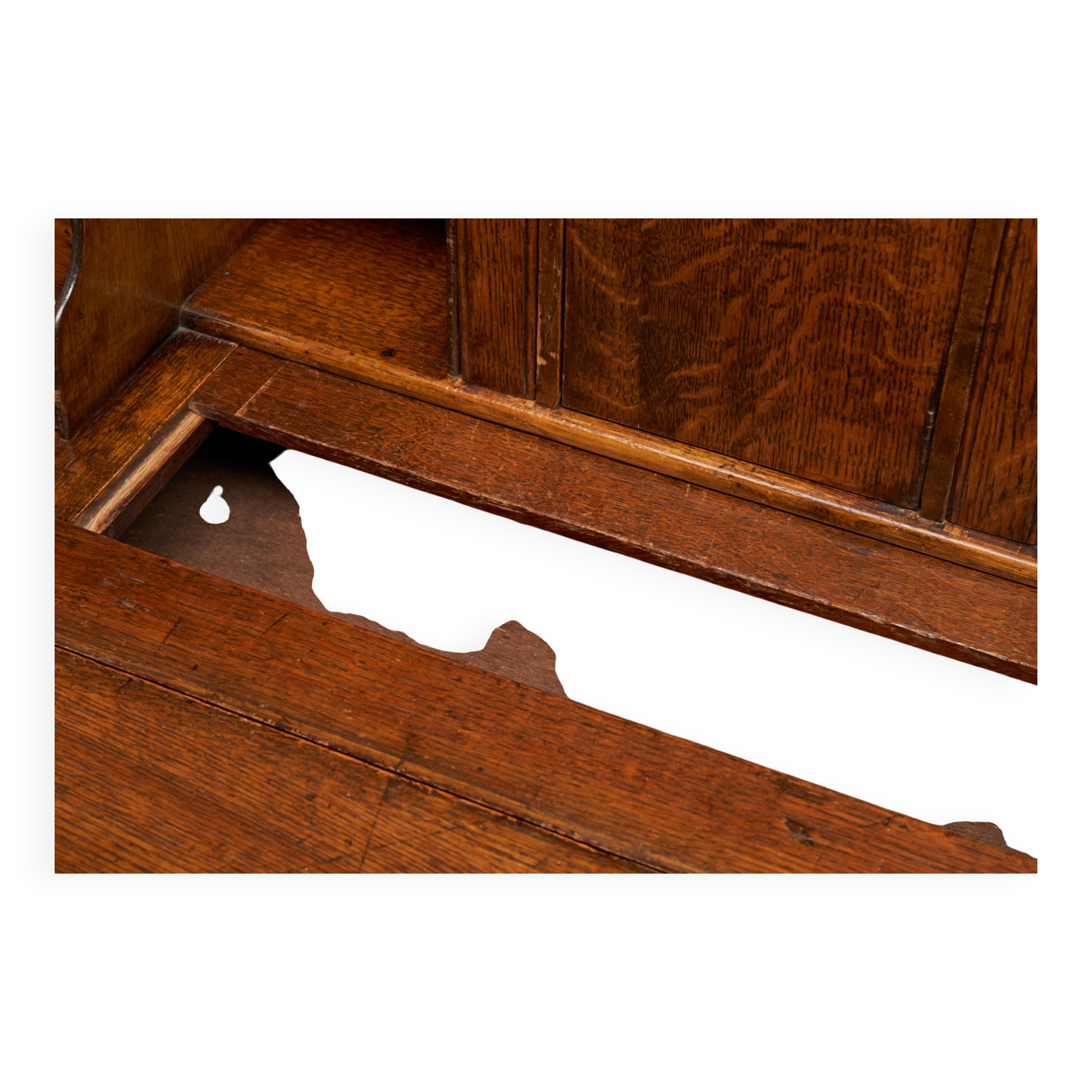 Antique English oak secretary with drop-down front.