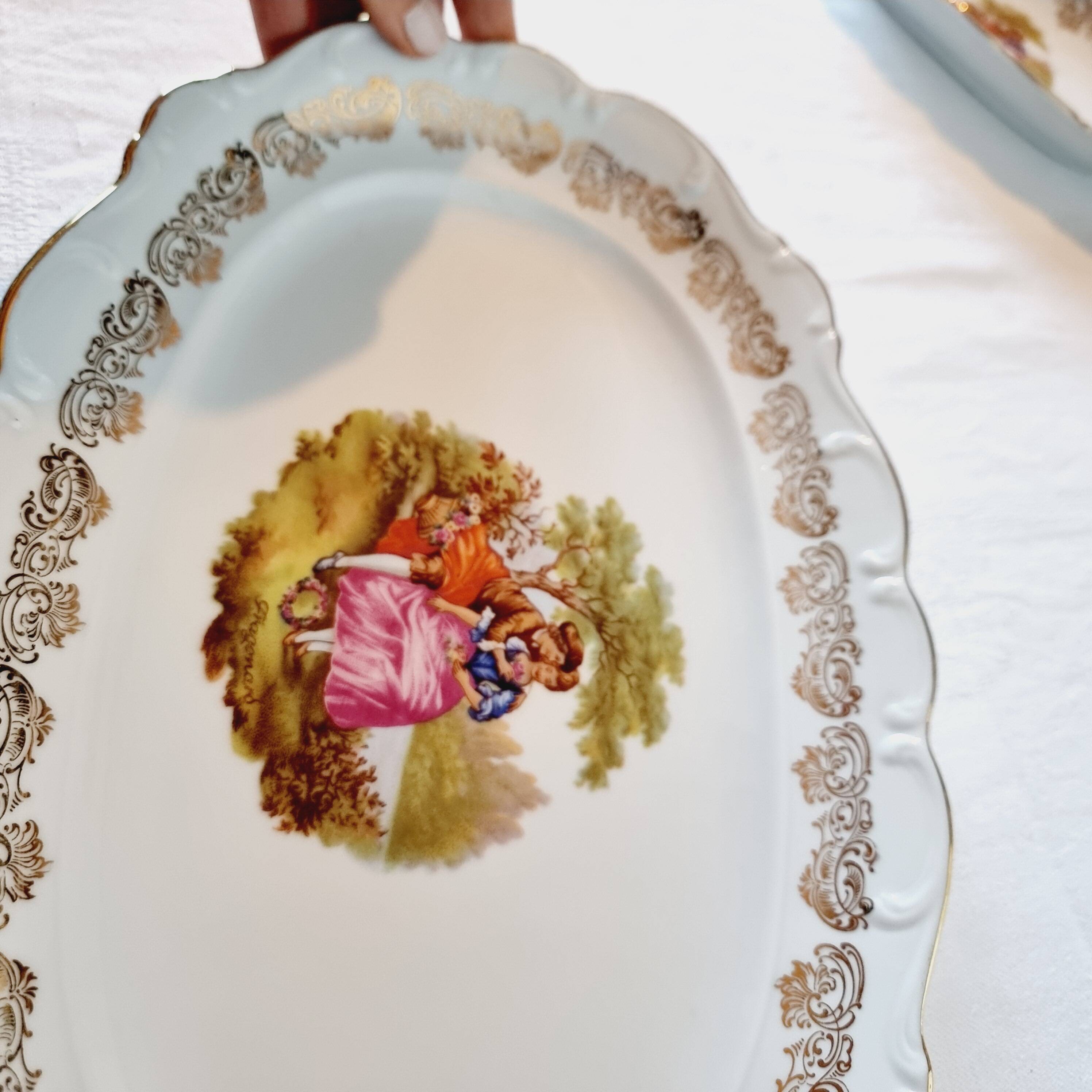 3 serving dishes with frangonard romantic scene with designs and borders in 24 carat gold.