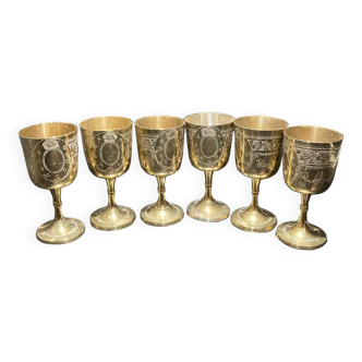 Set of six gold metal glasses
