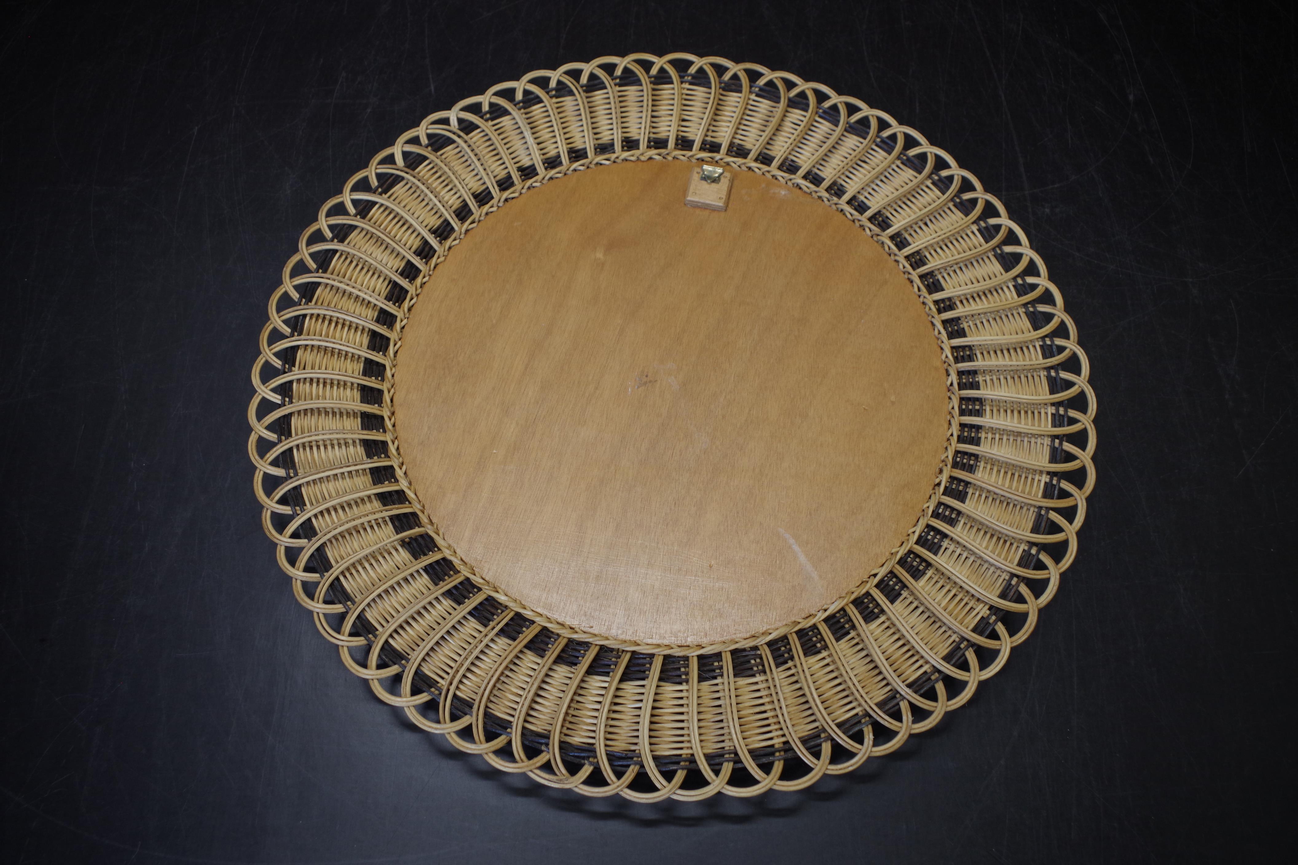 Vintage round mirror in a wicker frame