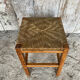 Tabouret ancien en bois sculpté et paille