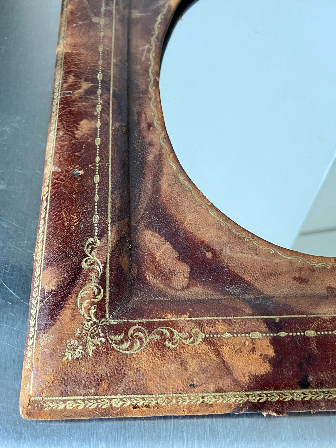 Antique leather framed mirror with gildings 30 cm x  24 cm