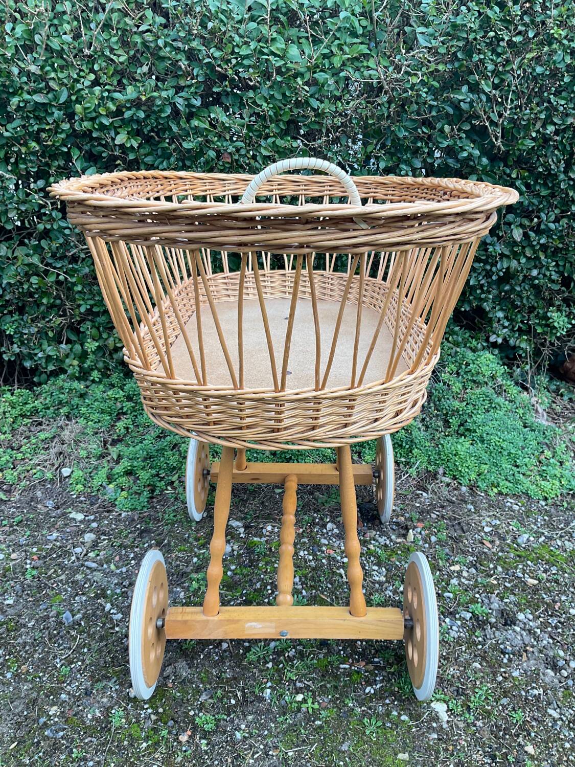 Vintage wicker cradle on casters