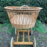 Vintage wicker cradle on casters