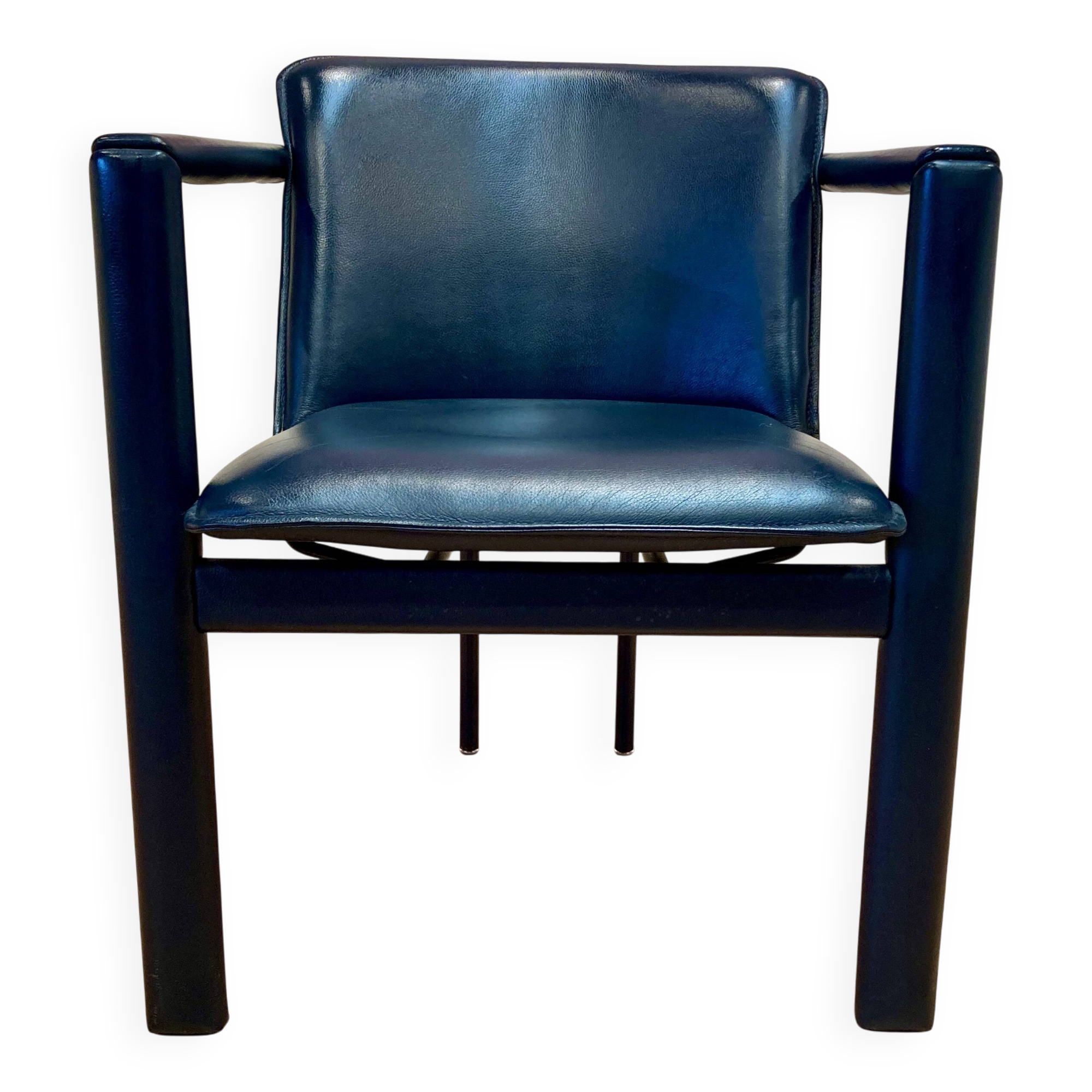 Design armchair in leather and metal.