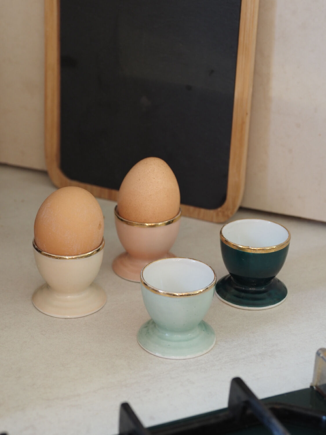 Four coloured egg cups with a golden rim from the 50s.