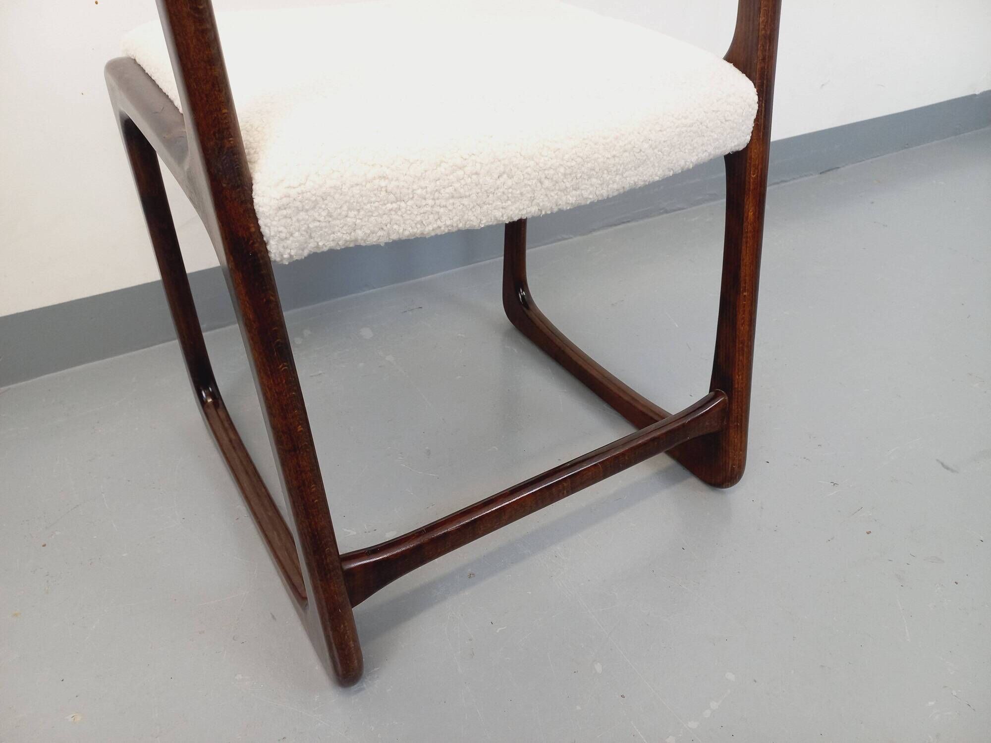 Vintage sled chair by Baumann in wood and boucle fabric.