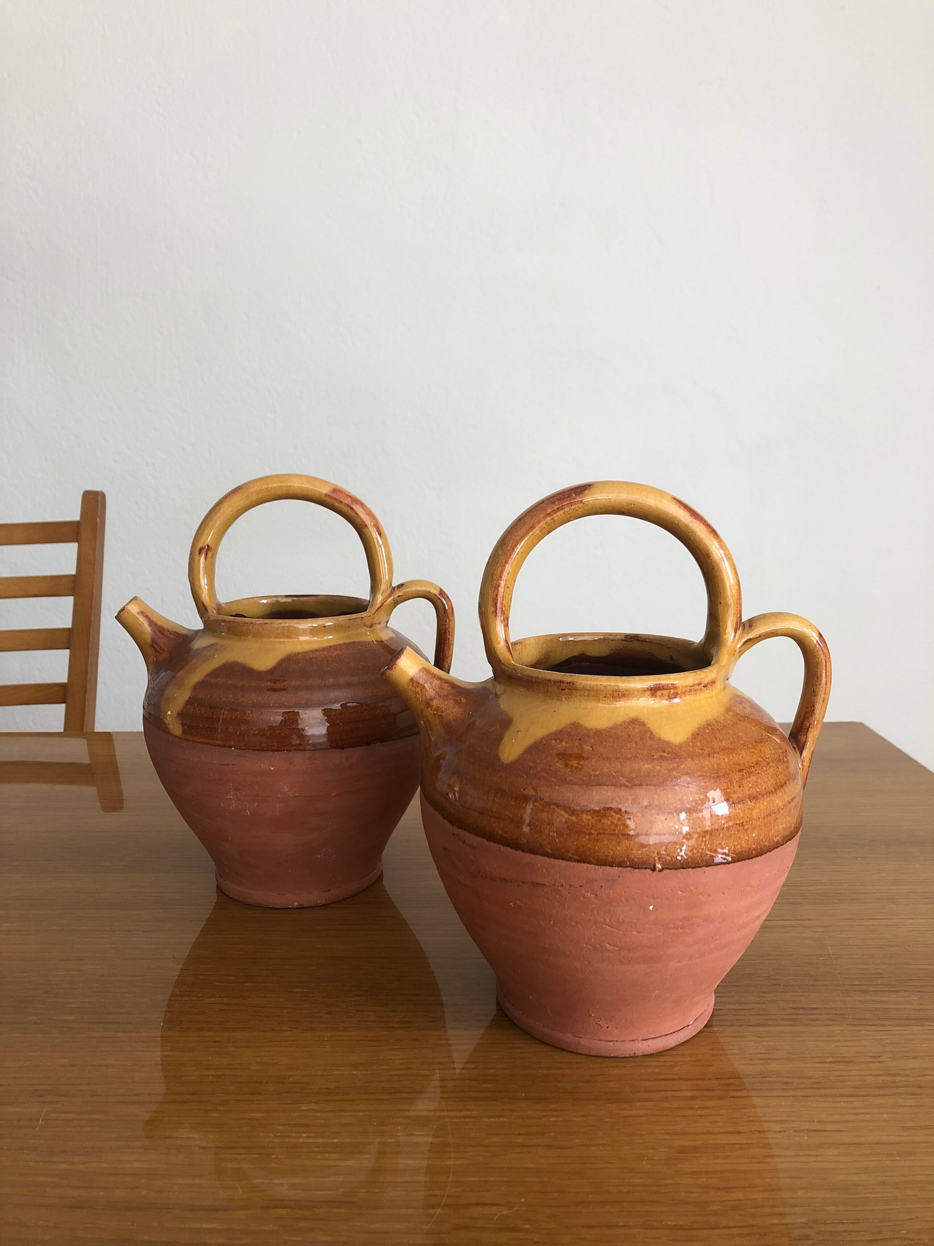 Pair of vintage terracotta watering cans