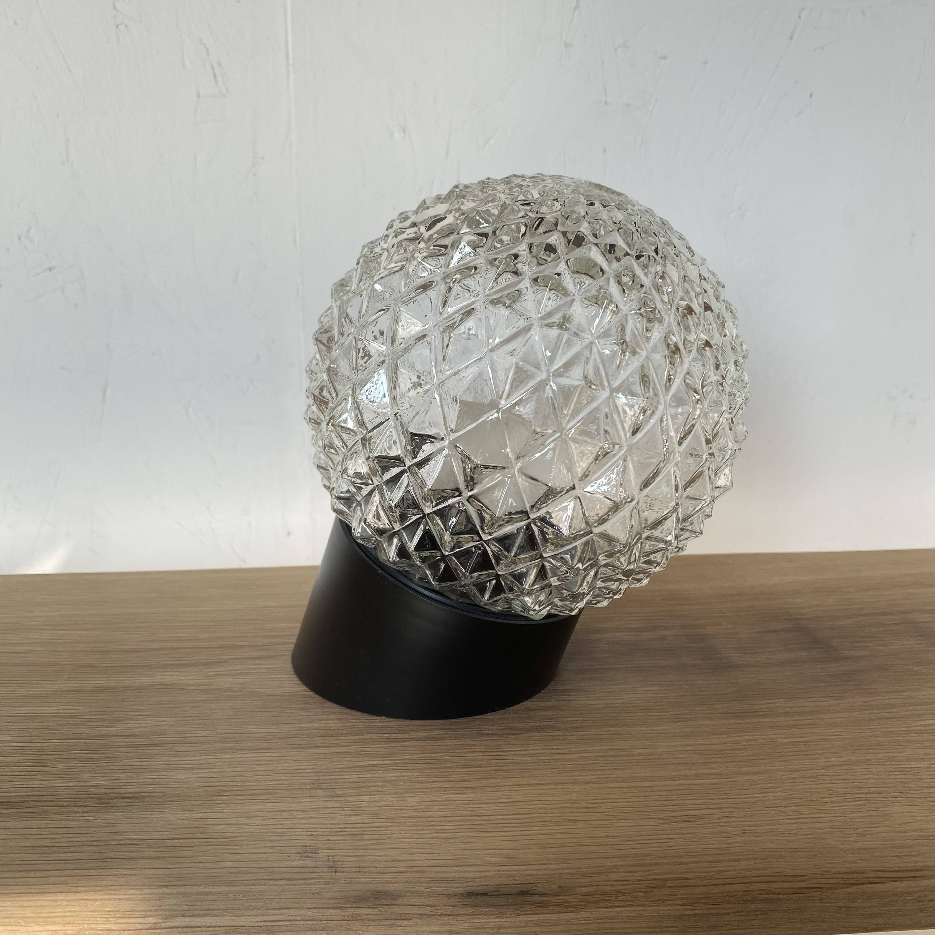 Pair of slanted glass wall lights with black plastic base, decorative v