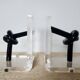 Bookends in plexiglass and knotted black tubes, 1980s design.
