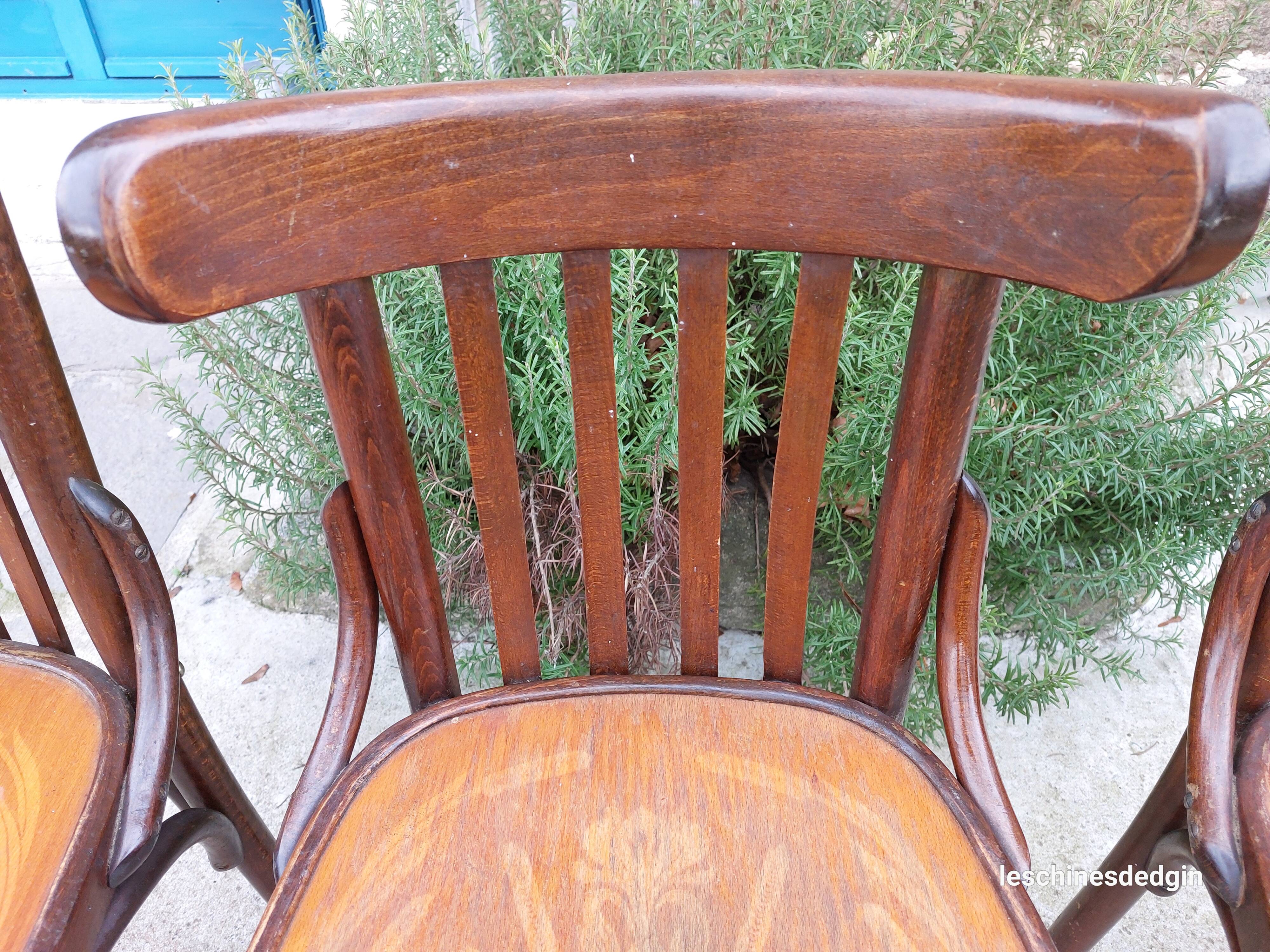 4 bentwood bistro chairs with a pattern on the seat