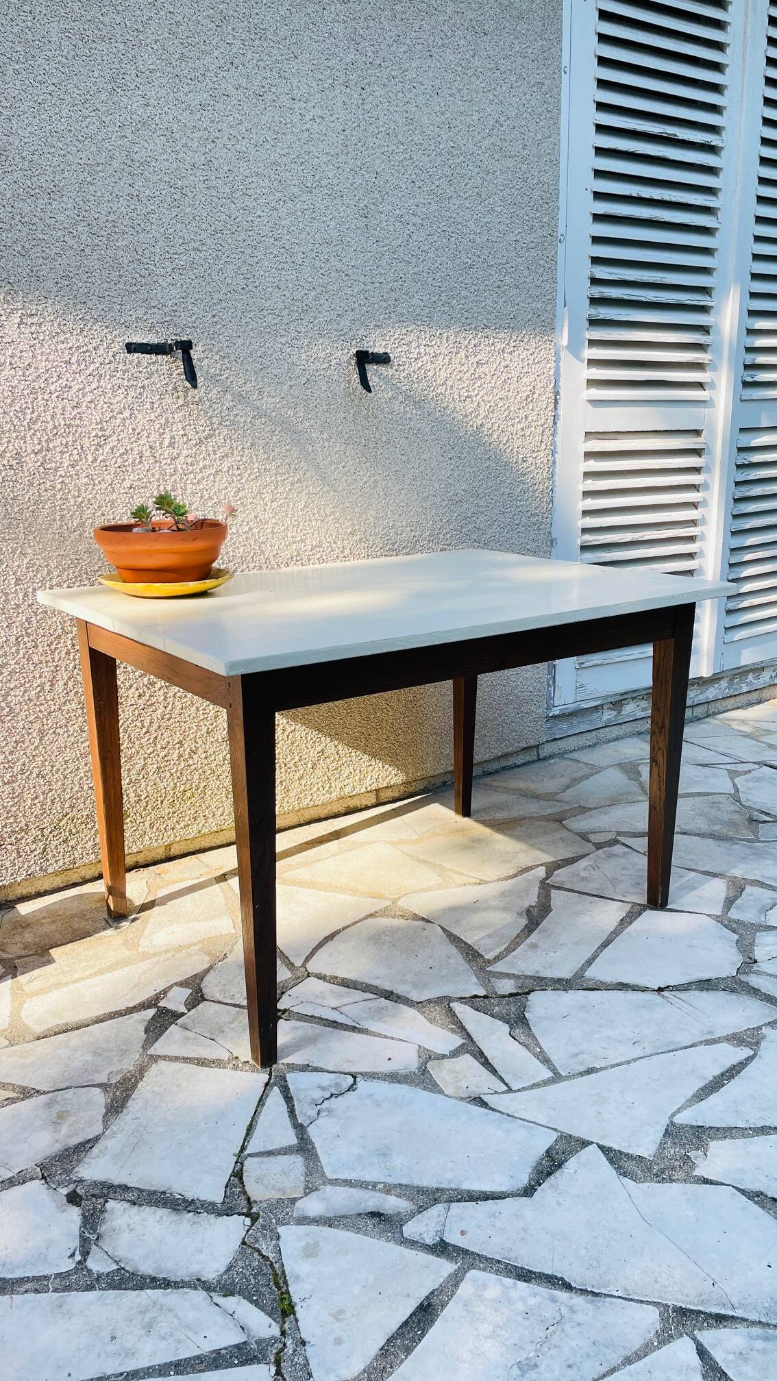 Vintage oak farmhouse table with a white top.