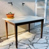 Vintage oak farmhouse table with a white top.
