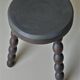 Set of side table and 2 stools, stained black wood, Circa 1950.