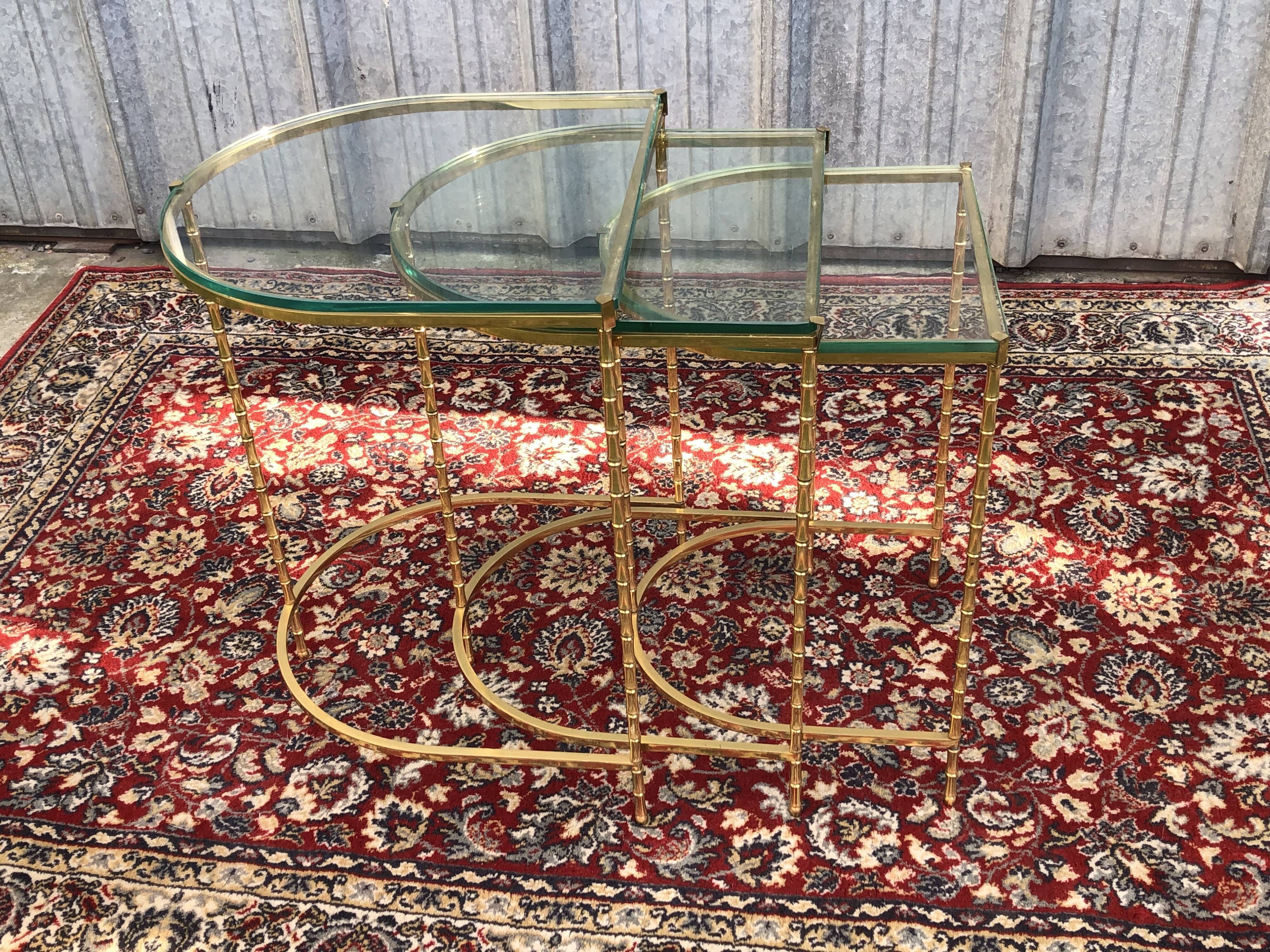 Suite of 3 trundle tables in golden brinze and glass slabs period 1970/1980