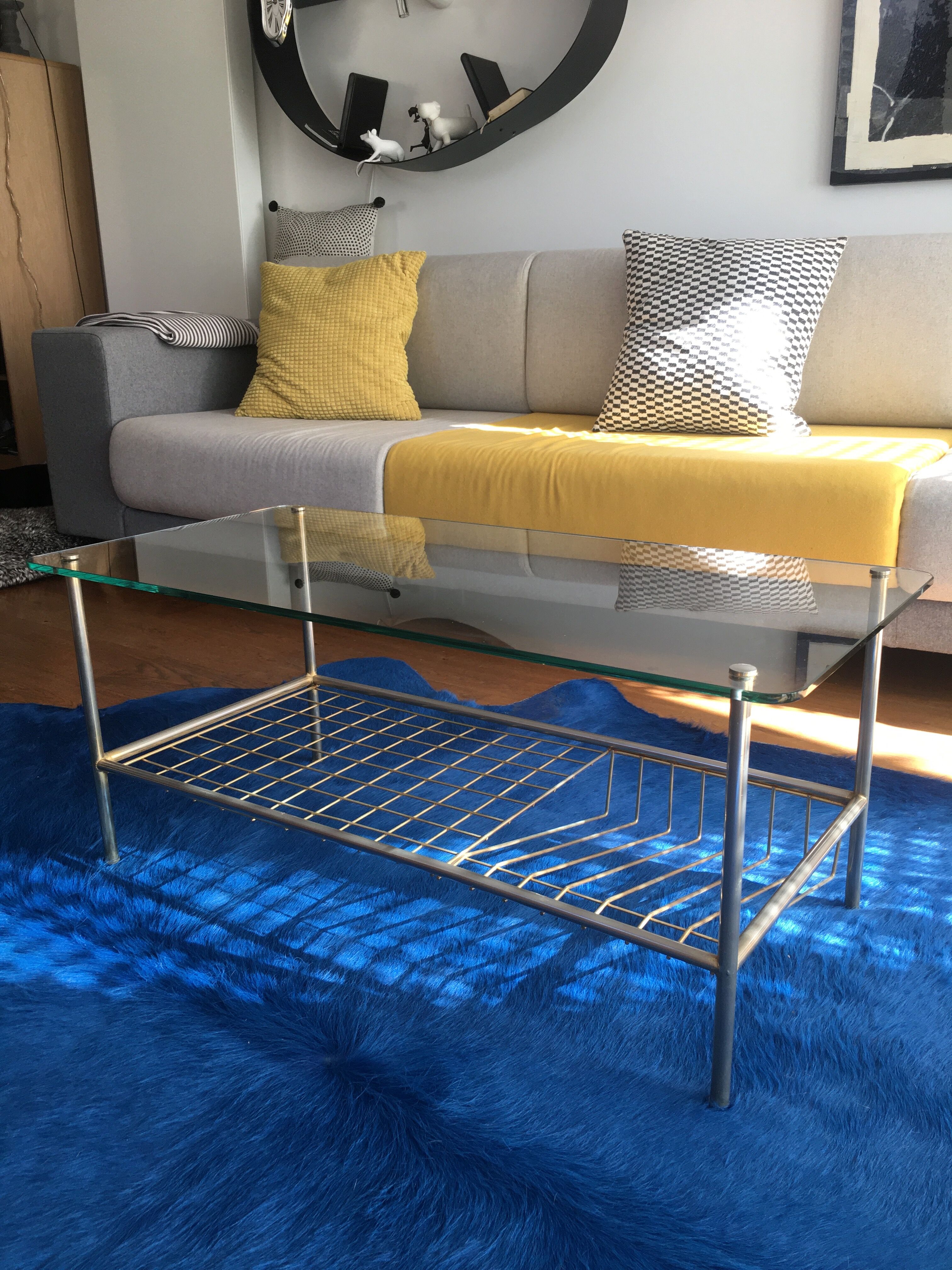 Glass coffee table with gold metal magazine holder