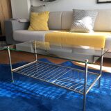 Glass coffee table with gold metal magazine holder