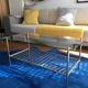 Glass coffee table with gold metal magazine holder