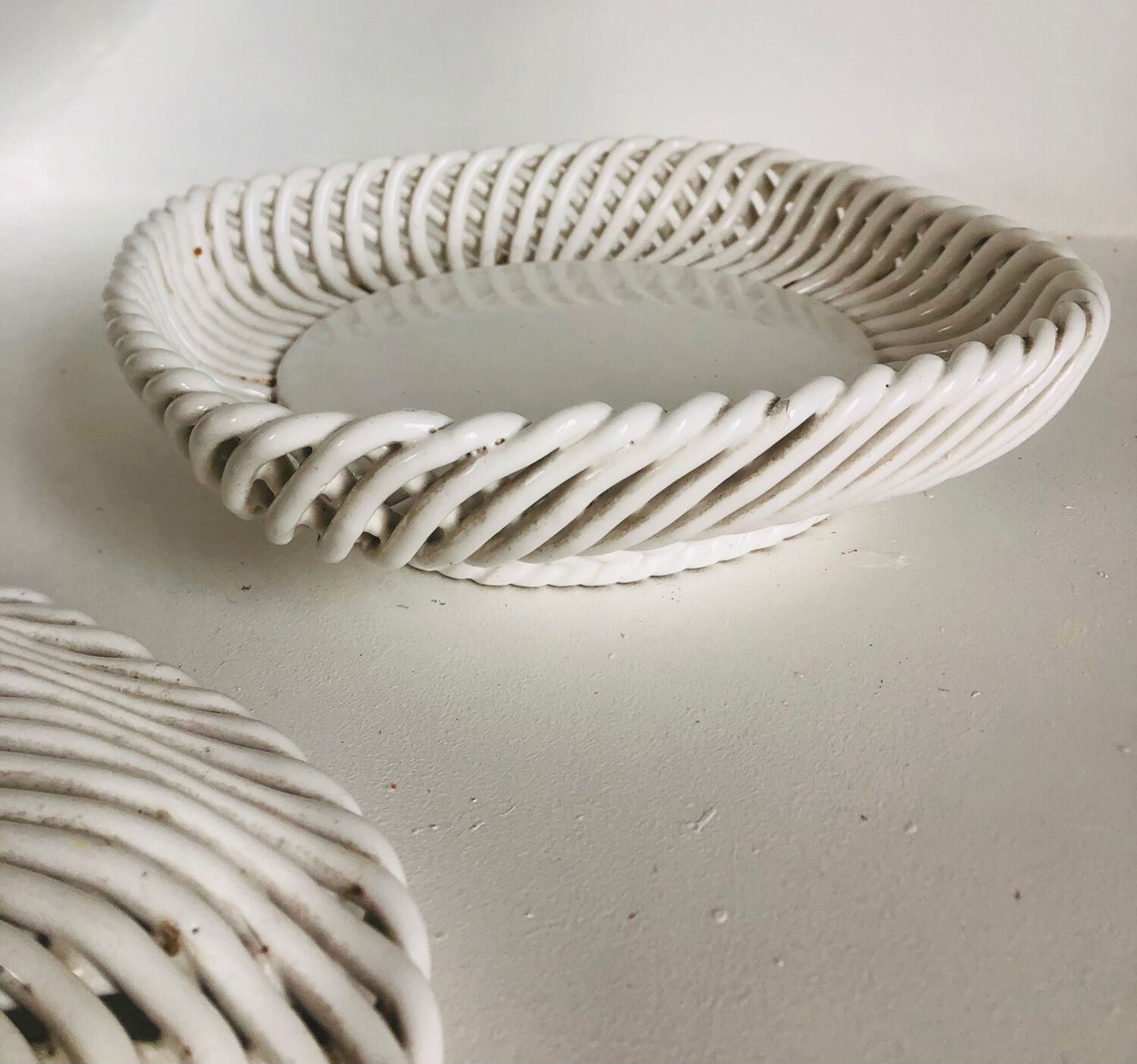 Covered basket in woven ceramic and fruit slip.