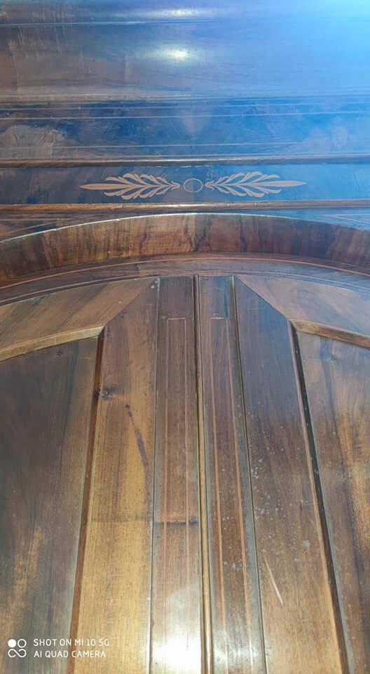 A walnut wardrobe with marquetry and boxwood stringing, dating from the Consulate period, circa 1810.