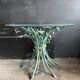 Vintage console in patinated metal with reed leaves.