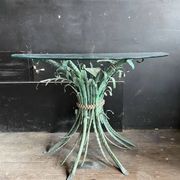 Vintage console in patinated metal with reed leaves.
