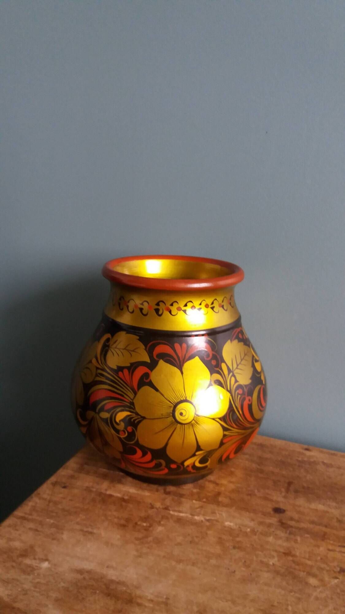 Khokhloma vase, Russian lacquered wood craftsmanship, hand-painted floral decoration.