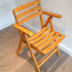 Paire de fauteuils pliants en bois vernis signé Clairitex