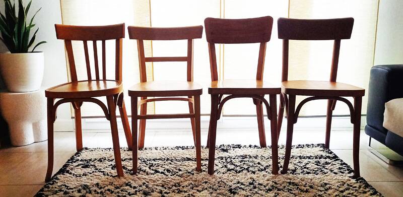 Set of 4 light wood bistro chairs stamped Baumann and Thonet.