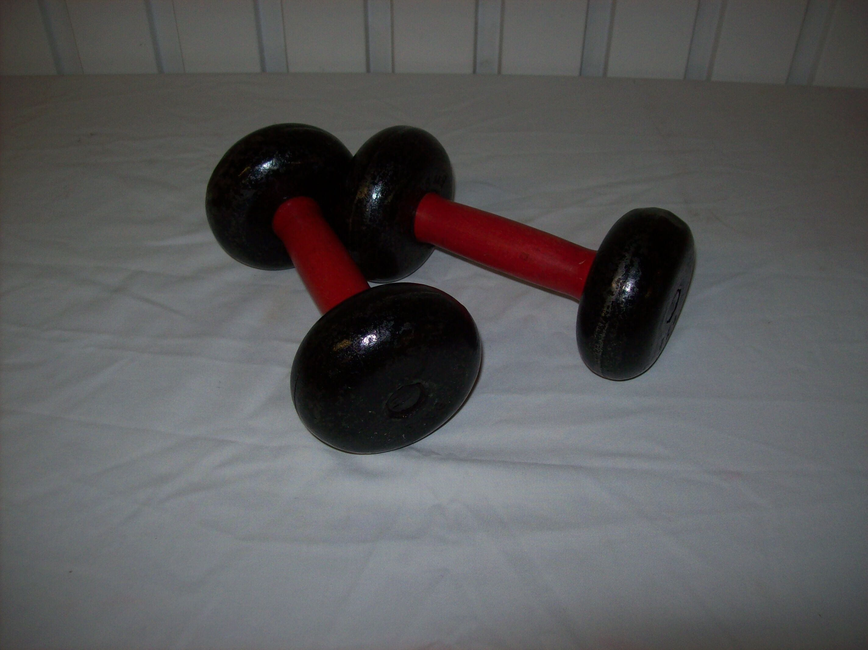 Red wooden and cast-iron dumbbells