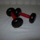 Red wooden and cast-iron dumbbells