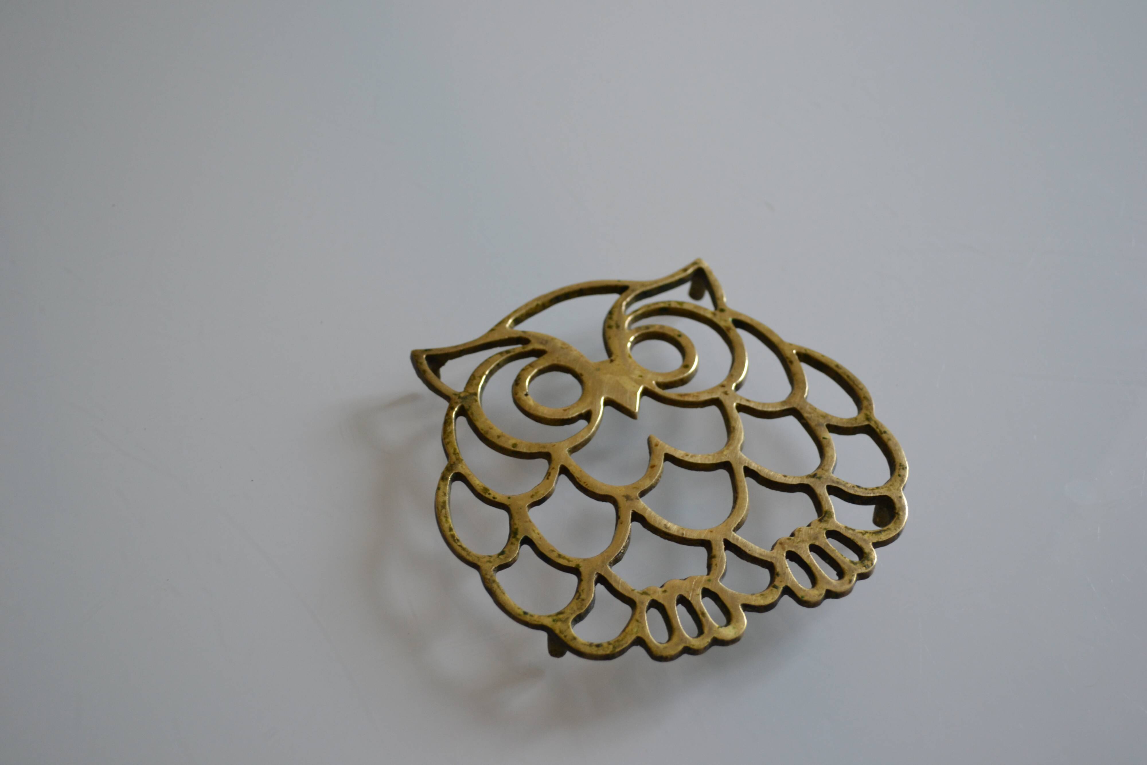 Vintage openwork brass trivet in the shape of an owl or owl