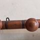 Wall-mounted coat rack with 8 turned wooden hooks in faux bamboo style.