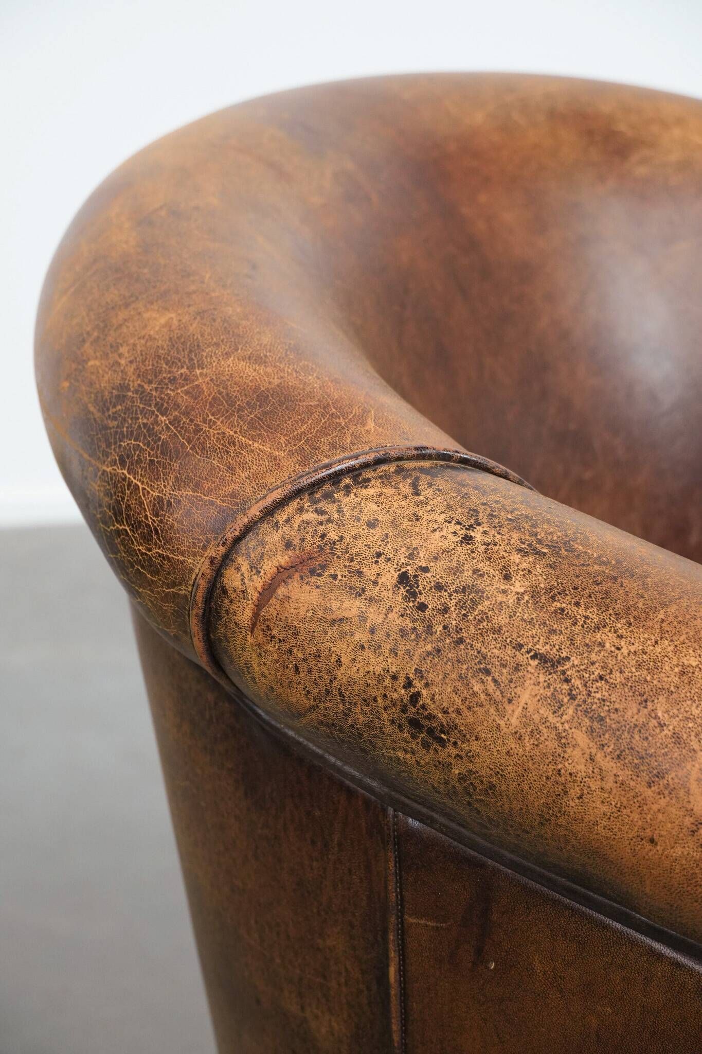 Vintage club chair in sheepskin leather with a characterful look