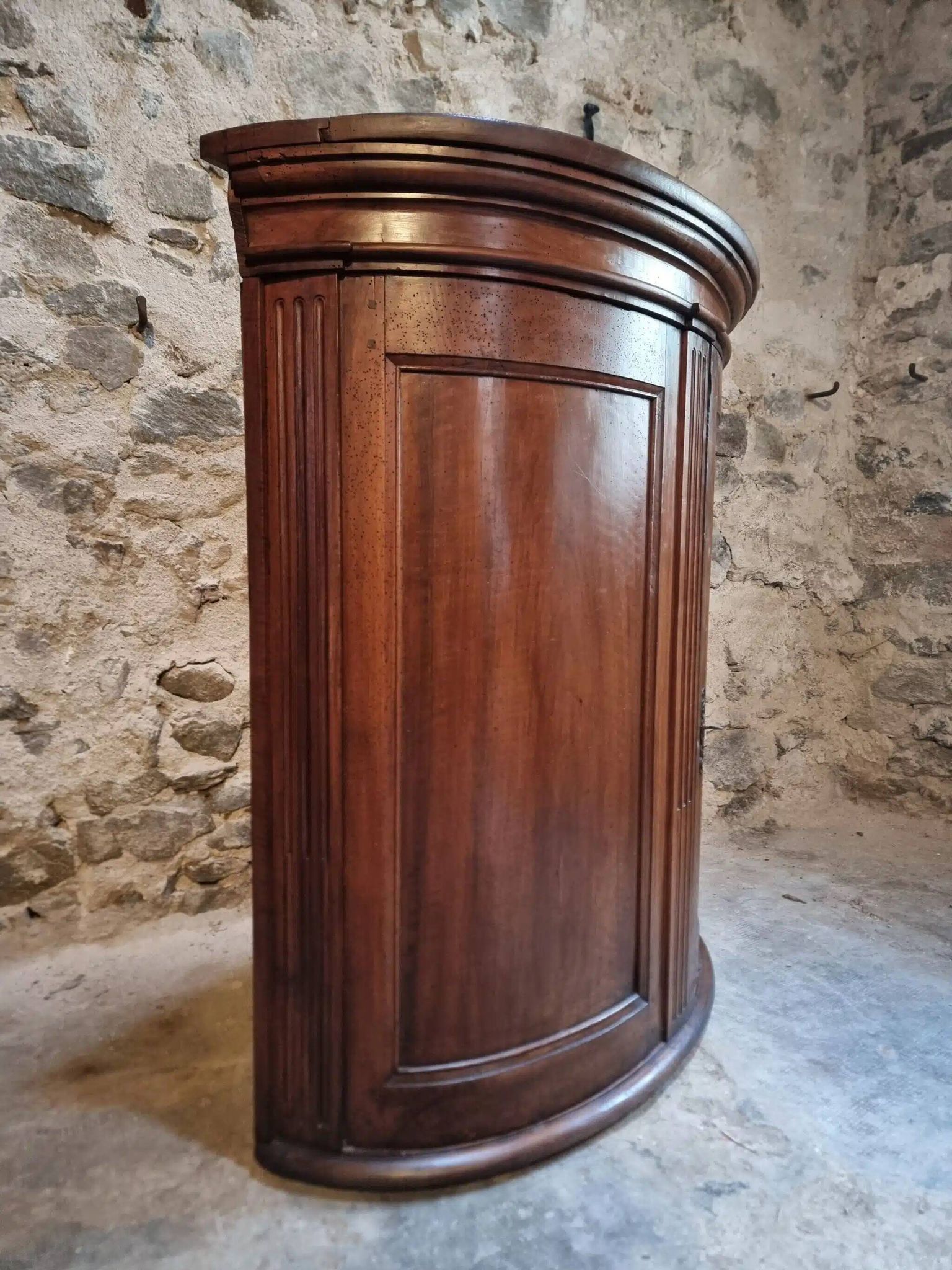 Antique demi-lune cabinet in walnut, late 18th century, French château.