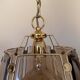 Pair of vintage pendant lights in smoked glass and gold metal, Hollywood style.