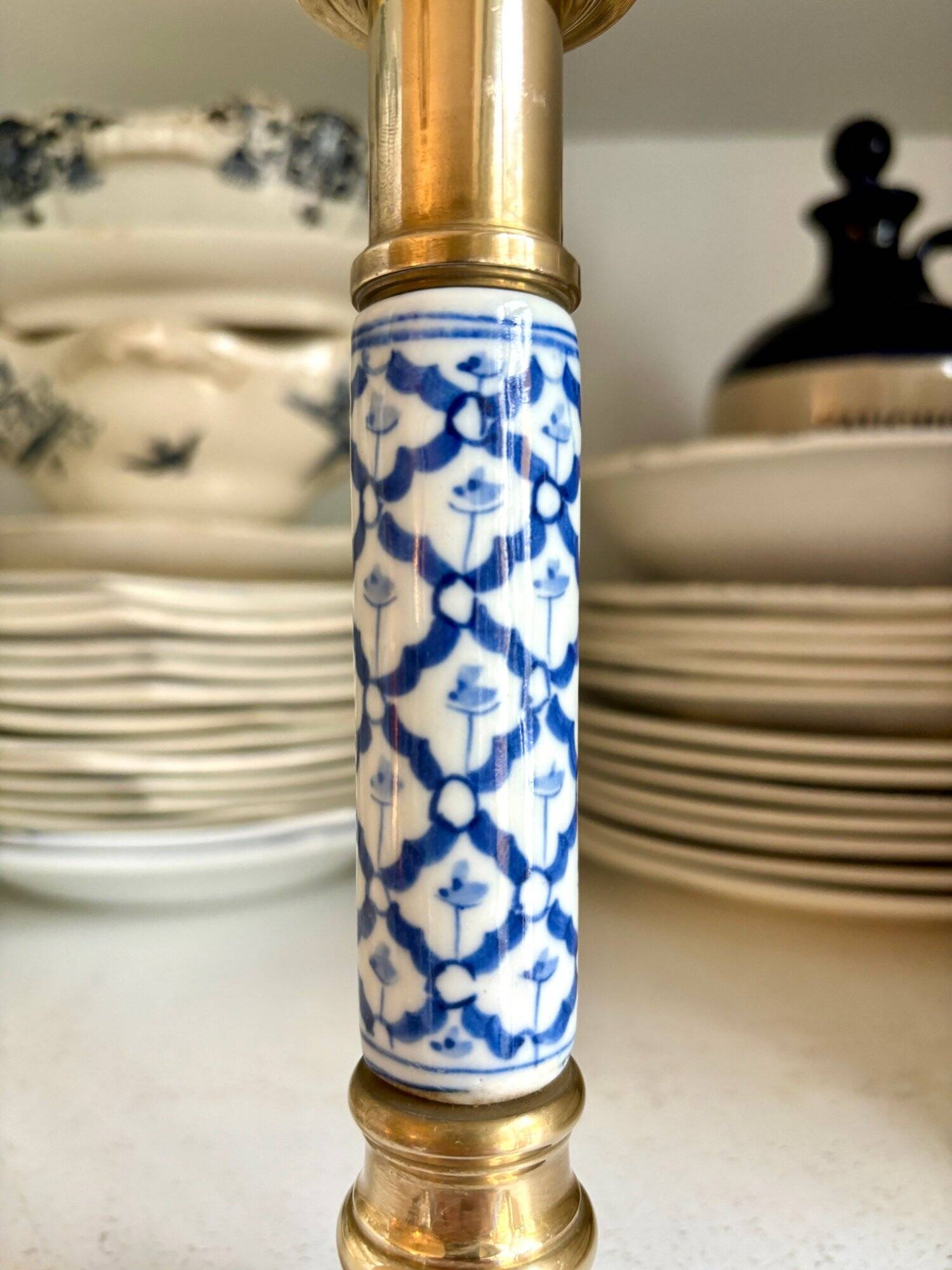 Candlestick in gilded brass and blue earthenware