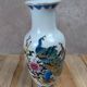 Asian vase decorated with peacock in porcelain