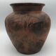 Vase or pot in brown terracotta with artistic decoration of fish.