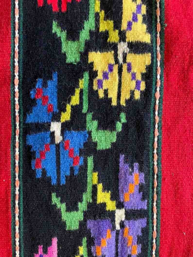 Romanian wool rug, red background with delicate colourful flowers