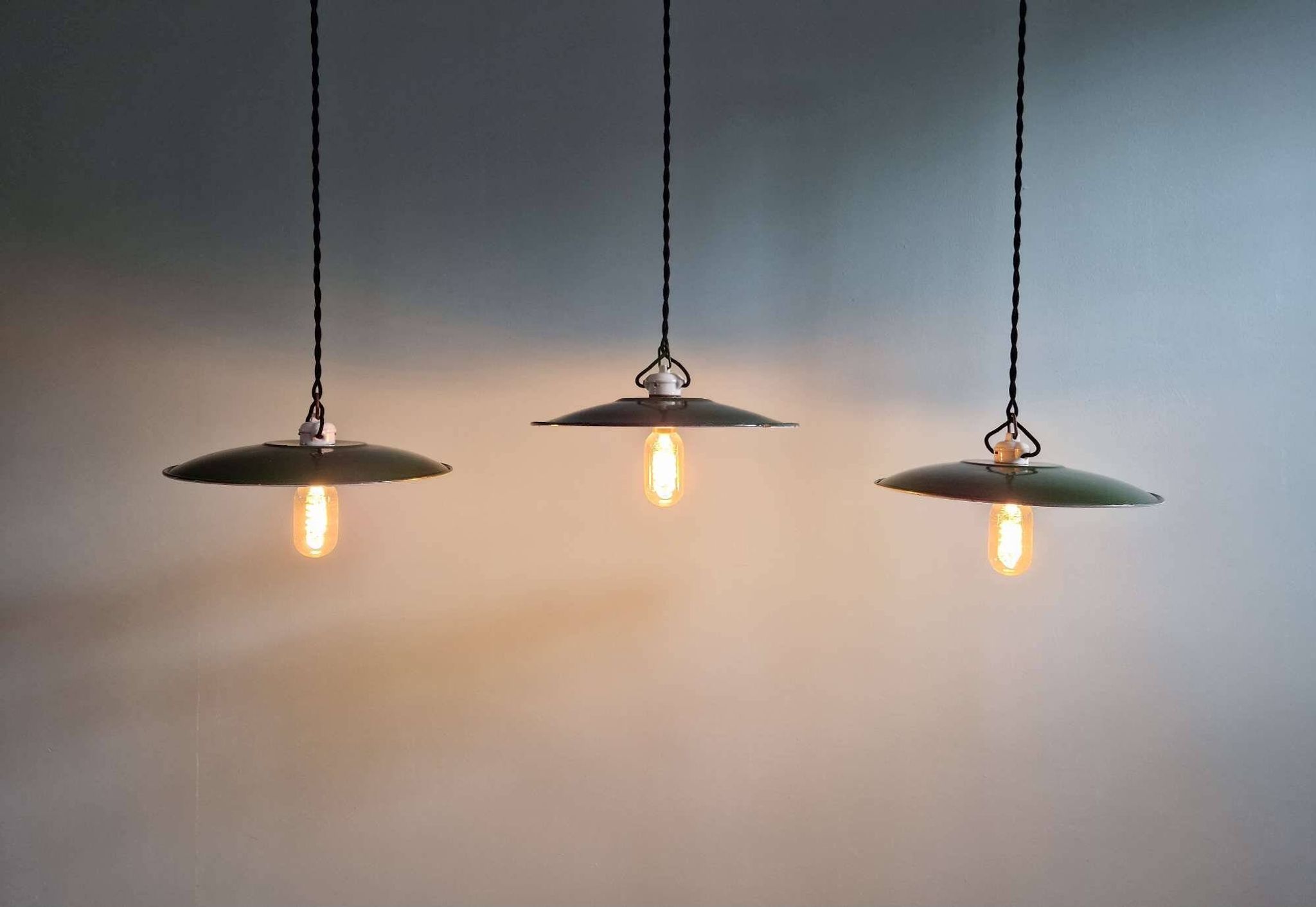 Trio of large industrial suspensions in green enamelled sheet metal.