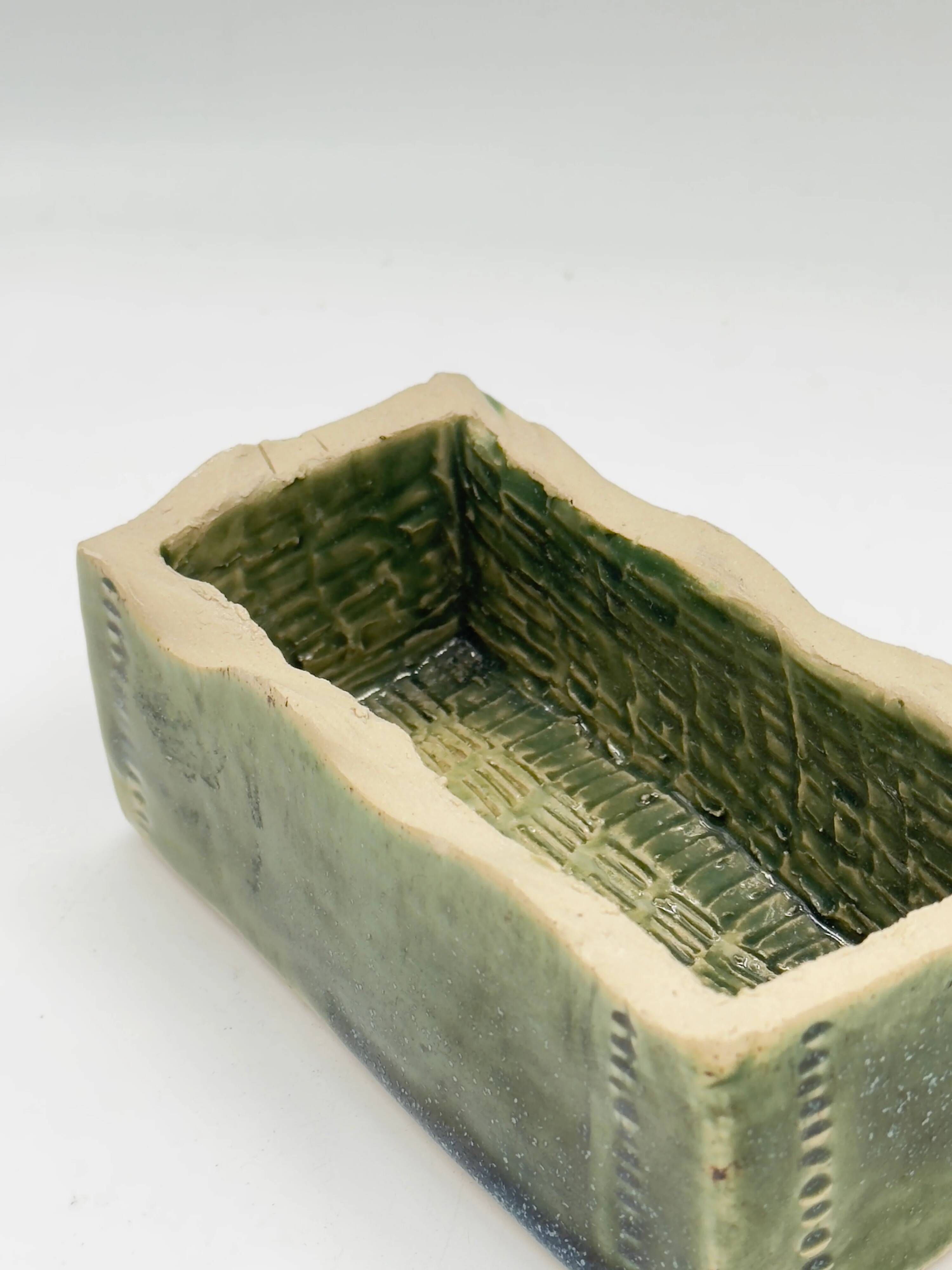 Rectangular ceramic vase signed, woven interior.