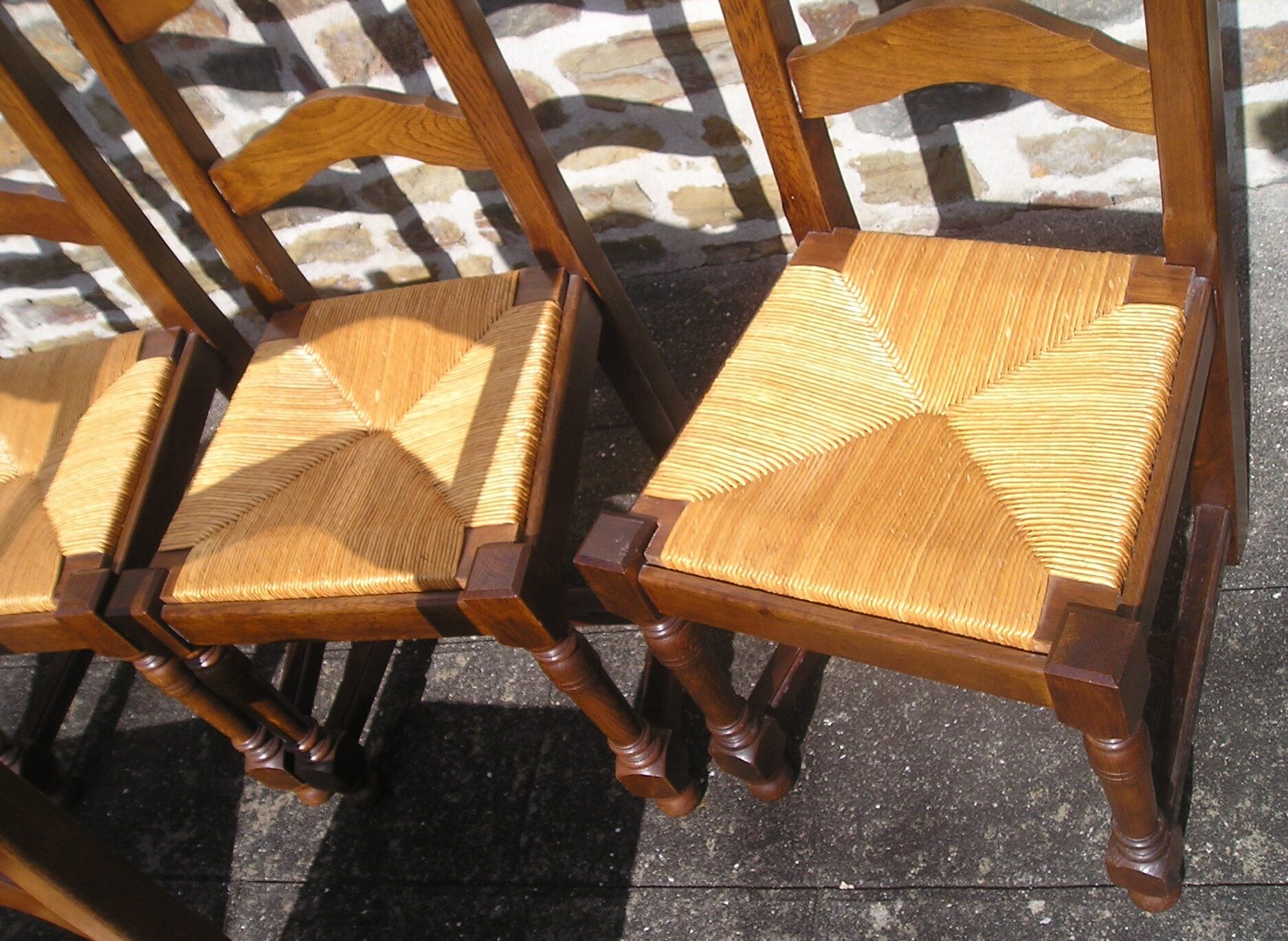 Set of 6 oak dining chairs with high backs and straw seats