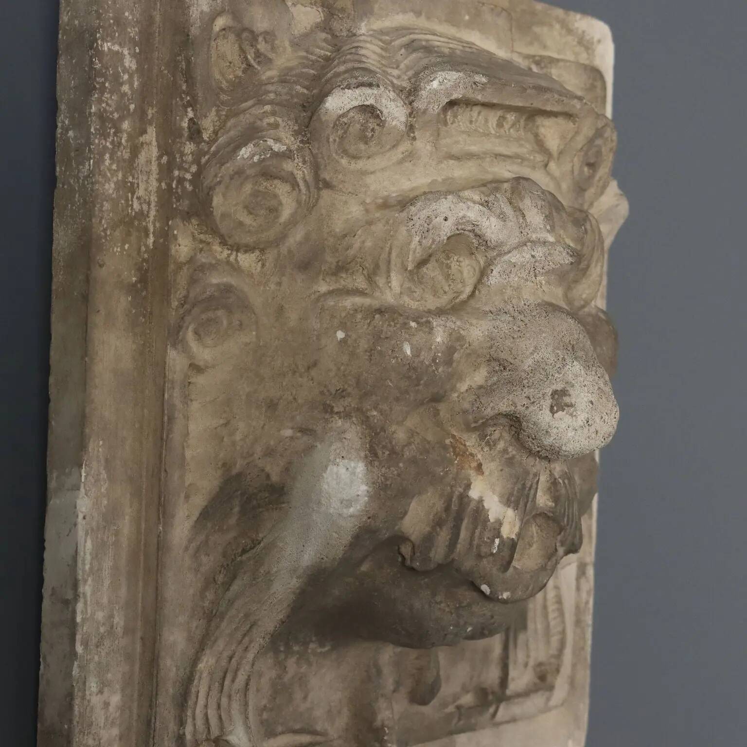 Old plaster tile with a fierce mask decoration, Italy, 19th century.